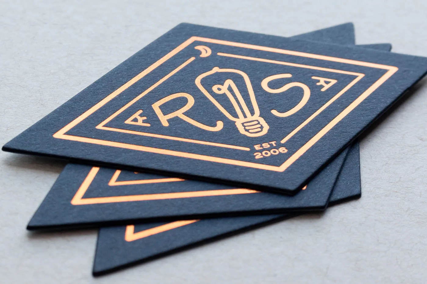 Die cut copper foil business cards in diamond shape