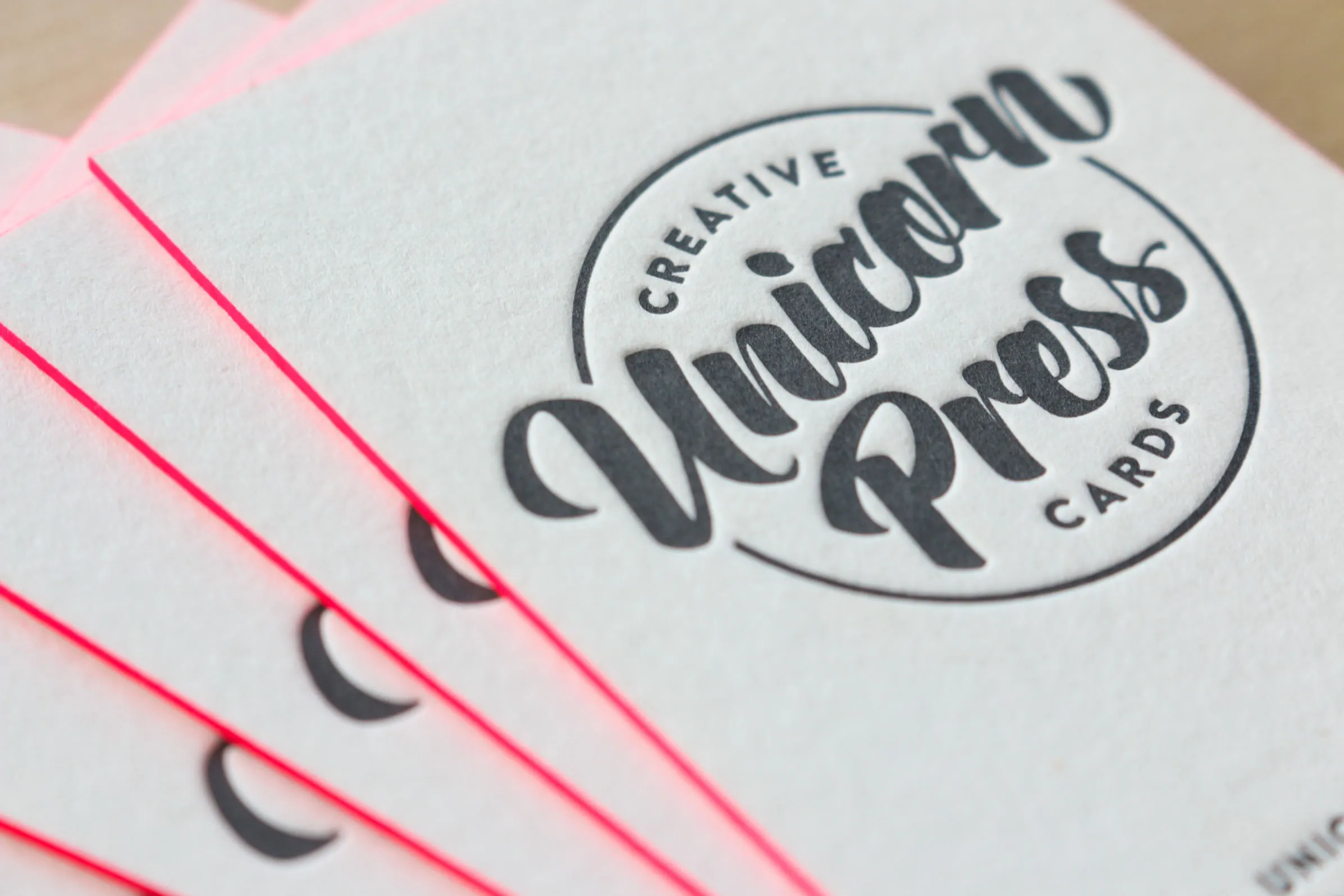 Neon pink edge painting on letterpress cards