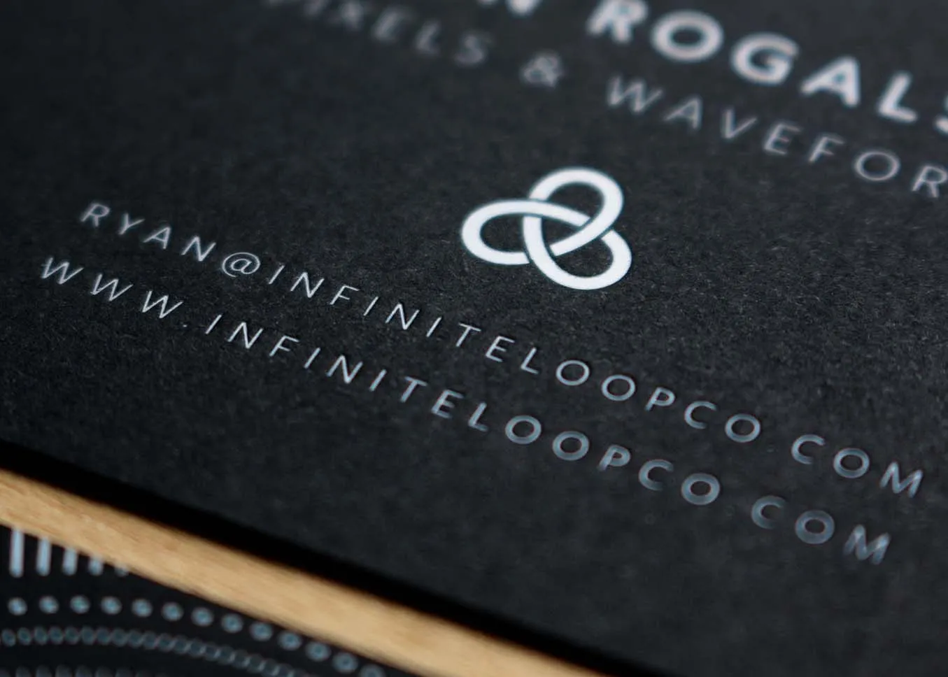 White foil business card — detail of foil stamping